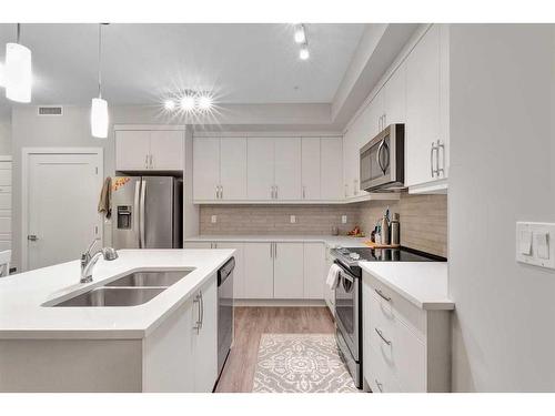 111-300 Auburn Meadows Manor Se, Calgary, AB - Indoor Photo Showing Kitchen With Stainless Steel Kitchen With Double Sink With Upgraded Kitchen