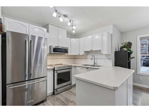 1102-7171 Coach Hill Road Sw, Calgary, AB - Indoor Photo Showing Kitchen With Double Sink