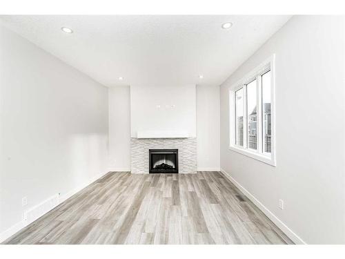 23 Homestead Passage Ne, Calgary, AB - Indoor Photo Showing Other Room With Fireplace