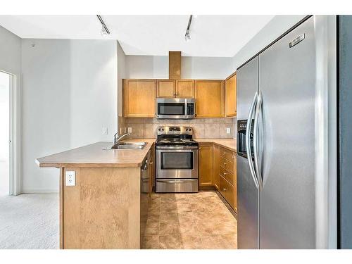 3401-92 Crystal Shores Road, Okotoks, AB - Indoor Photo Showing Kitchen With Stainless Steel Kitchen With Double Sink