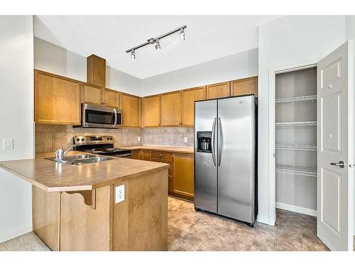 3401-92 Crystal Shores Road, Okotoks, AB - Indoor Photo Showing Kitchen With Stainless Steel Kitchen With Double Sink