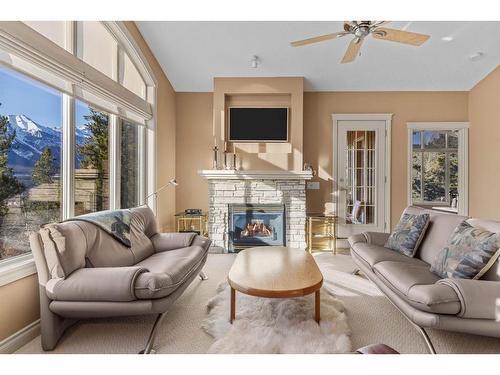 303-3 Aspen Glen, Canmore, AB - Indoor Photo Showing Living Room With Fireplace