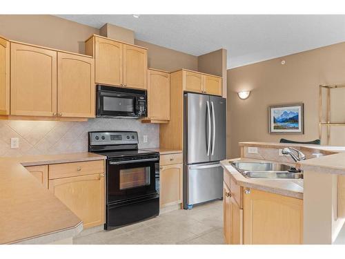 303-3 Aspen Glen, Canmore, AB - Indoor Photo Showing Kitchen With Double Sink