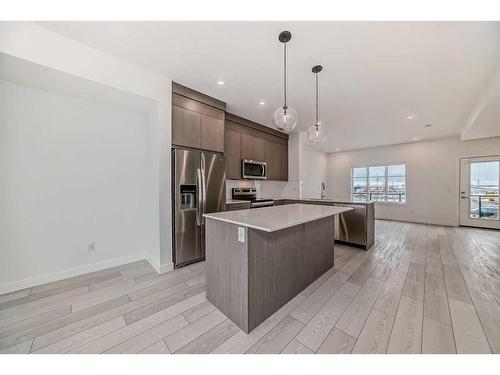 102-6 Merganser Drive West, Chestermere, AB - Indoor Photo Showing Kitchen With Stainless Steel Kitchen With Upgraded Kitchen