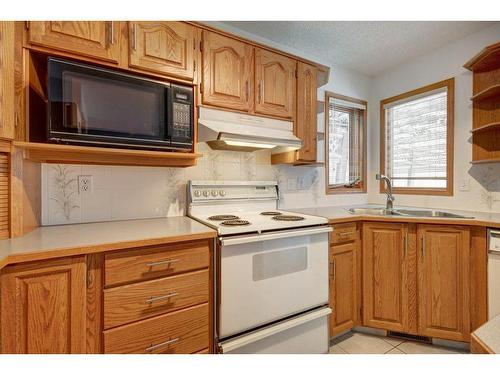 65 Christie Park View Sw, Calgary, AB - Indoor Photo Showing Kitchen With Double Sink