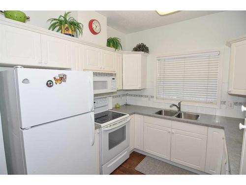 305-6800 Hunterview Drive Nw, Calgary, AB - Indoor Photo Showing Kitchen With Double Sink