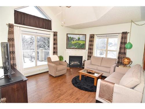 305-6800 Hunterview Drive Nw, Calgary, AB - Indoor Photo Showing Living Room With Fireplace