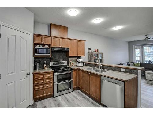 1202-2066 Luxstone Boulevard Sw, Airdrie, AB - Indoor Photo Showing Kitchen With Double Sink