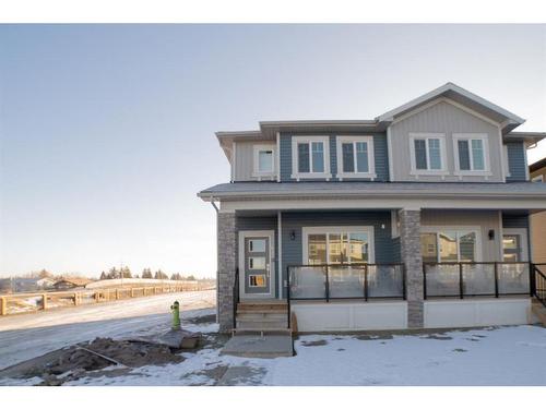 261 Midgrove Mews Sw, Airdrie, AB - Outdoor With Facade