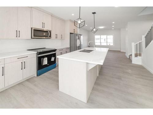 261 Midgrove Mews Sw, Airdrie, AB - Indoor Photo Showing Kitchen With Stainless Steel Kitchen With Double Sink With Upgraded Kitchen