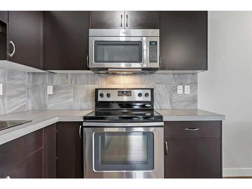 306-250 Sage Valley Road Nw, Calgary, AB - Indoor Photo Showing Kitchen With Stainless Steel Kitchen With Upgraded Kitchen