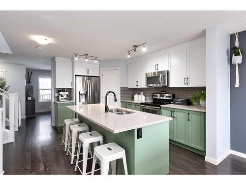 11 Reunion Grove Nw, Airdrie, AB - Indoor Photo Showing Kitchen With Double Sink With Upgraded Kitchen