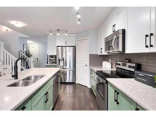 11 Reunion Grove Nw, Airdrie, AB - Indoor Photo Showing Kitchen With Double Sink With Upgraded Kitchen