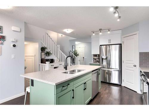 11 Reunion Grove Nw, Airdrie, AB - Indoor Photo Showing Kitchen With Double Sink With Upgraded Kitchen