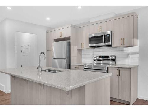 800 Windbury Street, Airdrie, AB - Indoor Photo Showing Kitchen With Double Sink With Upgraded Kitchen