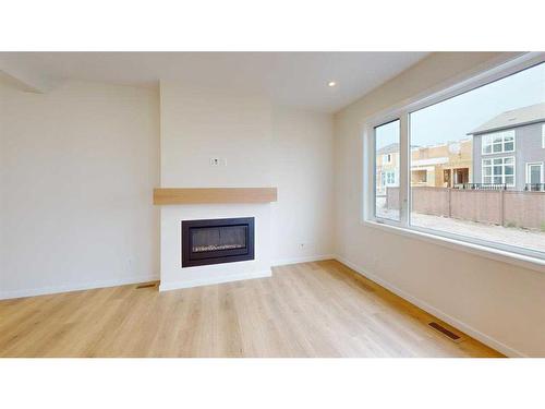 44 Sugarsnap Way Se, Calgary, AB - Indoor Photo Showing Living Room With Fireplace