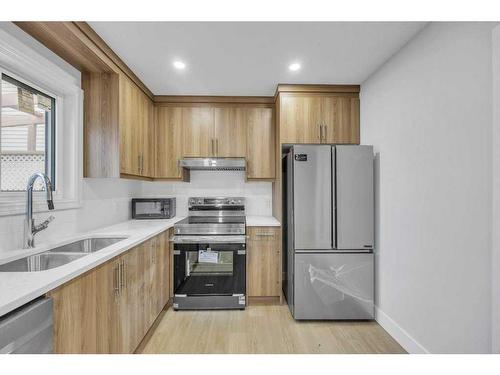 8 Martinglen Mews Ne, Calgary, AB - Indoor Photo Showing Kitchen With Stainless Steel Kitchen With Double Sink