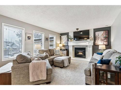 111 Inverness Drive Se, Calgary, AB - Indoor Photo Showing Living Room With Fireplace