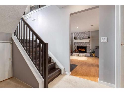 251 Queen Charlotte Way Se, Calgary, AB - Indoor Photo Showing Other Room With Fireplace