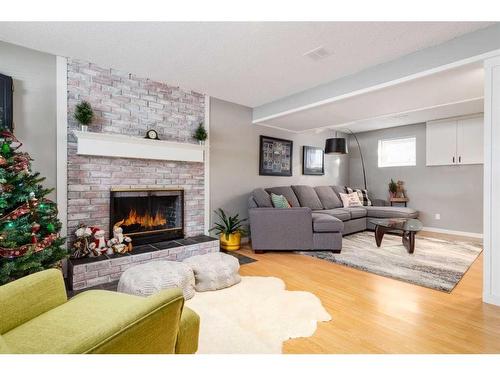 251 Queen Charlotte Way Se, Calgary, AB - Indoor Photo Showing Living Room With Fireplace