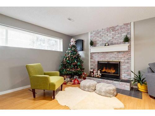 251 Queen Charlotte Way Se, Calgary, AB - Indoor Photo Showing Living Room With Fireplace