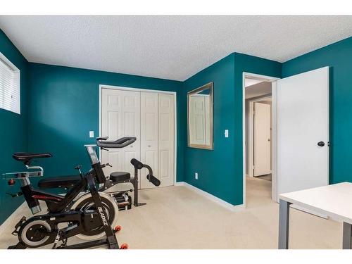 251 Queen Charlotte Way Se, Calgary, AB - Indoor Photo Showing Gym Room