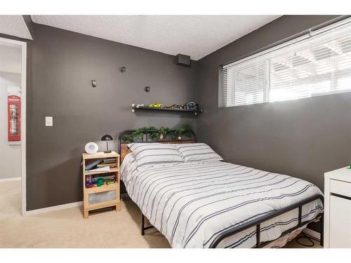 251 Queen Charlotte Way Se, Calgary, AB - Indoor Photo Showing Bedroom