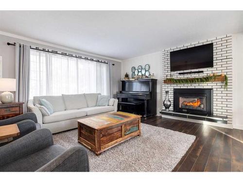 251 Queen Charlotte Way Se, Calgary, AB - Indoor Photo Showing Living Room With Fireplace