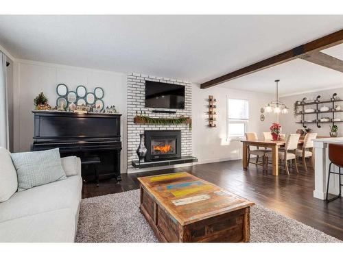 251 Queen Charlotte Way Se, Calgary, AB - Indoor Photo Showing Living Room With Fireplace