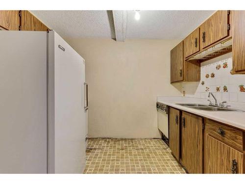 104-1512 16 Avenue Sw, Calgary, AB - Indoor Photo Showing Kitchen With Double Sink