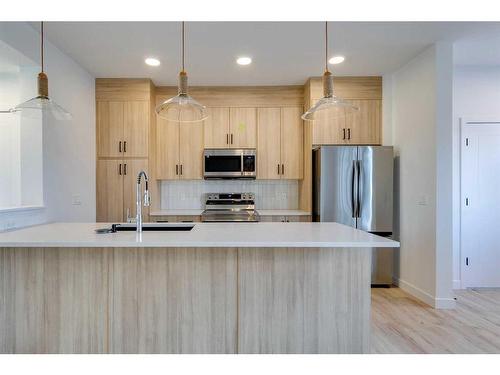 118 Clydesdale Avenue, Cochrane, AB - Indoor Photo Showing Kitchen With Upgraded Kitchen