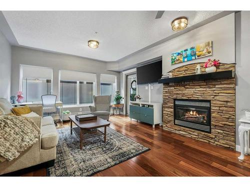 410-30 Discovery Ridge Close Sw, Calgary, AB - Indoor Photo Showing Living Room With Fireplace