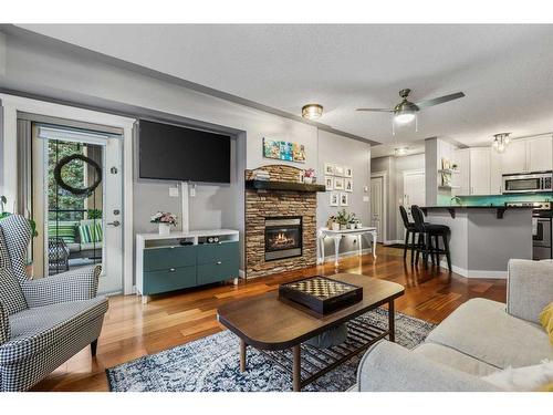 410-30 Discovery Ridge Close Sw, Calgary, AB - Indoor Photo Showing Living Room With Fireplace