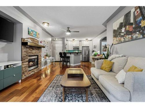 410-30 Discovery Ridge Close Sw, Calgary, AB - Indoor Photo Showing Living Room With Fireplace