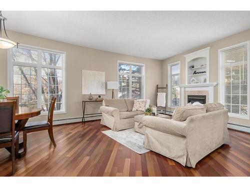 202-4835 Dalhousie Drive Nw, Calgary, AB - Indoor Photo Showing Living Room With Fireplace