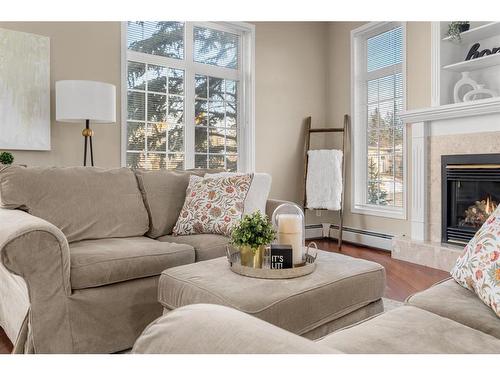 202-4835 Dalhousie Drive Nw, Calgary, AB - Indoor Photo Showing Living Room With Fireplace