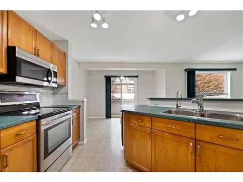 246 Bridelwood Court Sw, Calgary, AB - Indoor Photo Showing Kitchen With Double Sink