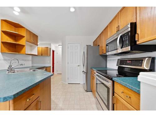 246 Bridelwood Court Sw, Calgary, AB - Indoor Photo Showing Kitchen With Double Sink