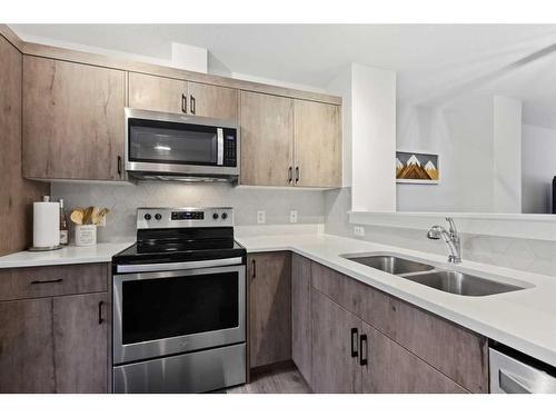 912 Cranbrook Walk Se, Calgary, AB - Indoor Photo Showing Kitchen With Stainless Steel Kitchen With Double Sink