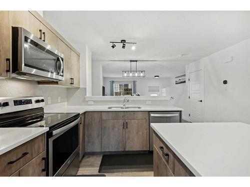 912 Cranbrook Walk Se, Calgary, AB - Indoor Photo Showing Kitchen With Stainless Steel Kitchen With Double Sink