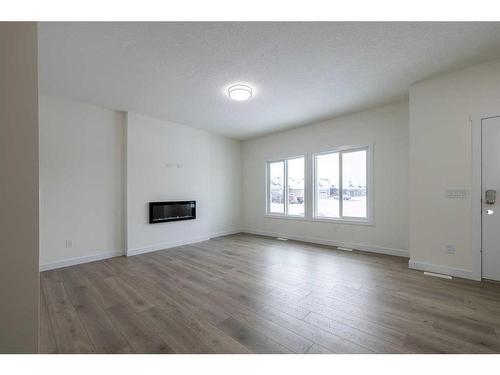 517 Clearwater Heath, Chestermere, AB - Indoor Photo Showing Other Room With Fireplace