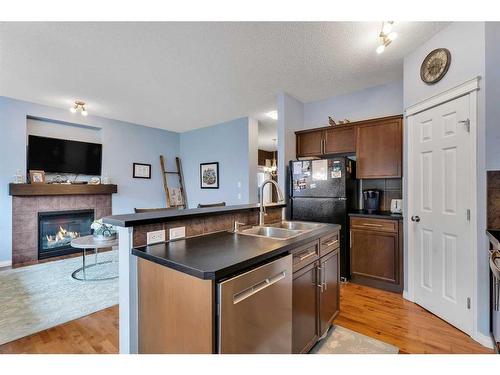 400 Kincora Glen Rise Nw, Calgary, AB - Indoor Photo Showing Kitchen With Fireplace With Double Sink