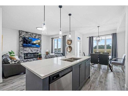 1033 Iron Landing Way, Crossfield, AB - Indoor Photo Showing Kitchen With Fireplace With Double Sink With Upgraded Kitchen