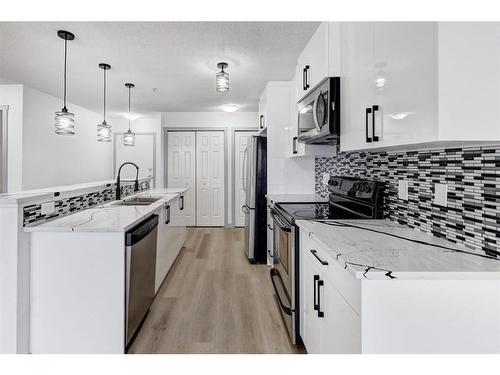 2217-700 Willowbrook Road Nw, Airdrie, AB - Indoor Photo Showing Kitchen With Stainless Steel Kitchen With Double Sink With Upgraded Kitchen