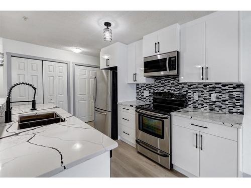 2217-700 Willowbrook Road Nw, Airdrie, AB - Indoor Photo Showing Kitchen With Stainless Steel Kitchen With Double Sink