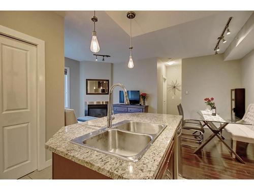 308-108 25 Avenue Sw, Calgary, AB - Indoor Photo Showing Kitchen With Fireplace With Double Sink