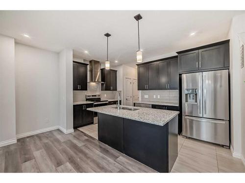 1453 Bayview Point Sw, Airdrie, AB - Indoor Photo Showing Kitchen With Stainless Steel Kitchen With Double Sink With Upgraded Kitchen