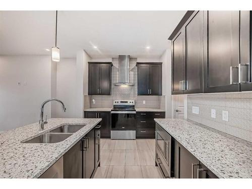 1453 Bayview Point Sw, Airdrie, AB - Indoor Photo Showing Kitchen With Stainless Steel Kitchen With Double Sink With Upgraded Kitchen