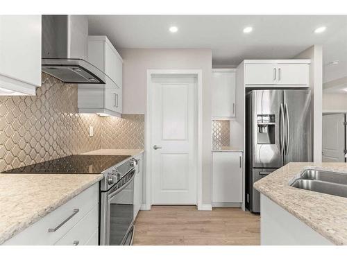 230 Hillcrest Square Sw, Airdrie, AB - Indoor Photo Showing Kitchen With Double Sink With Upgraded Kitchen