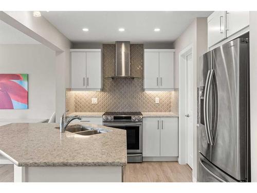 230 Hillcrest Square Sw, Airdrie, AB - Indoor Photo Showing Kitchen With Double Sink With Upgraded Kitchen